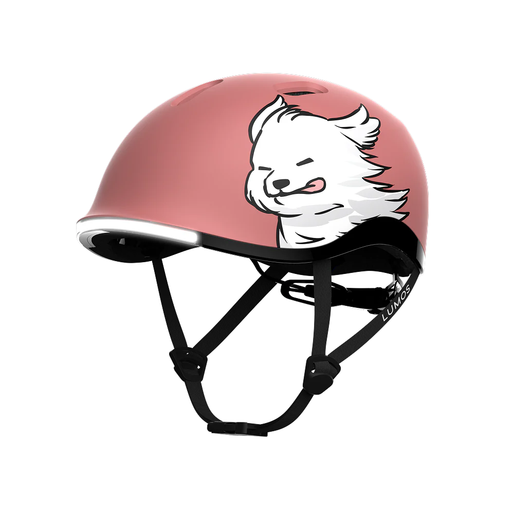 The Lumos NYXEL helmet is a pink high-visibility design from Lumos, featuring a cartoon illustration of a fluffy white dog with its tongue out on the side.