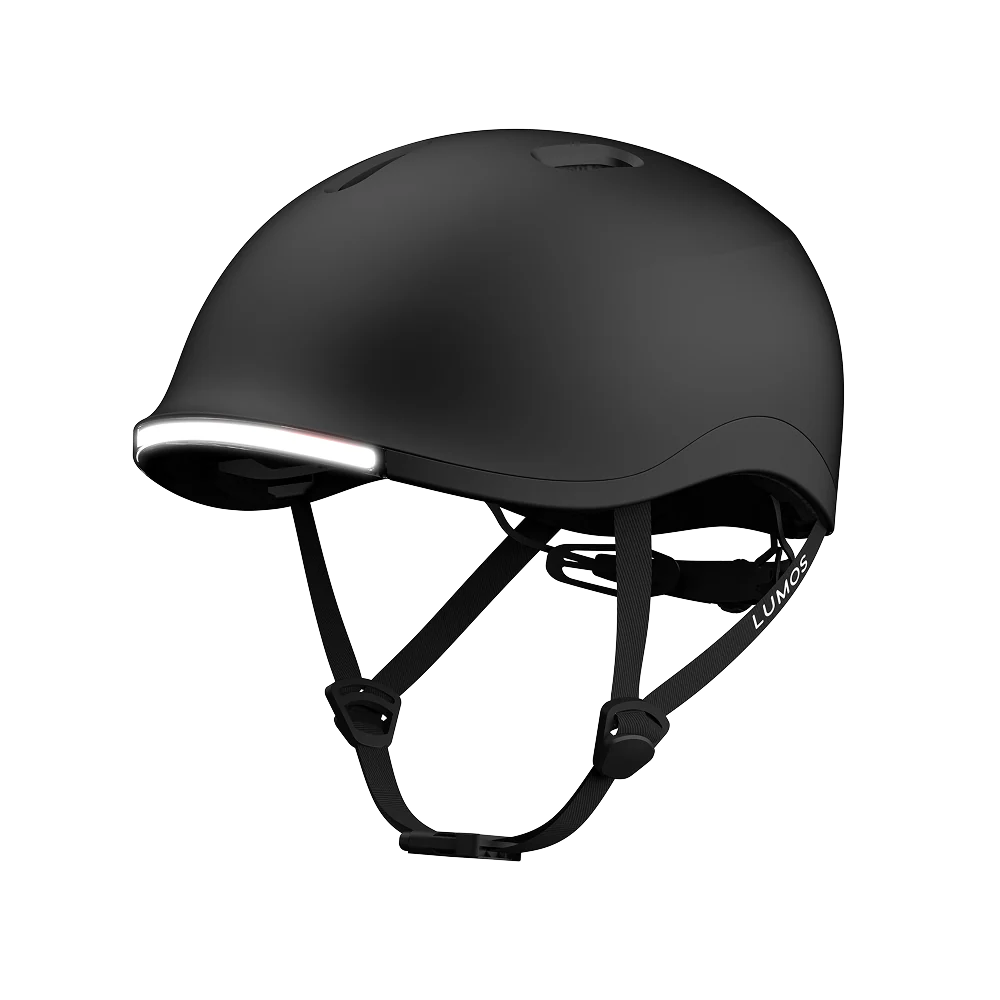 The Lumos NYXEL is a matte black smart bike helmet with an integrated front LED light, adjustable straps, and ventilation openings, displayed against a plain white background.
