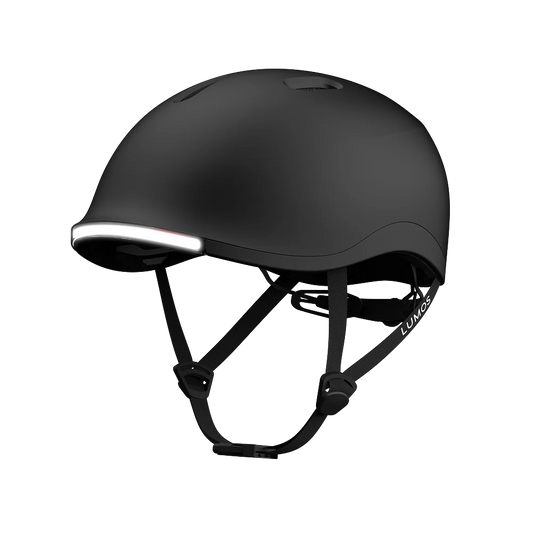 The Lumos NYXEL is a matte black smart bike helmet with an integrated front LED light, adjustable straps, and ventilation openings, displayed against a plain white background.
