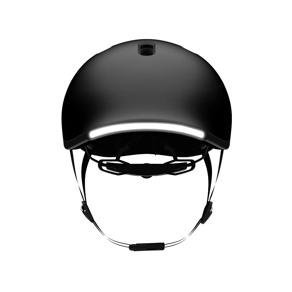 Front view of the Lumos NYXEL smart bike helmet in black, featuring a built-in LED light strip and adjustable chin straps, displayed on a white background.
