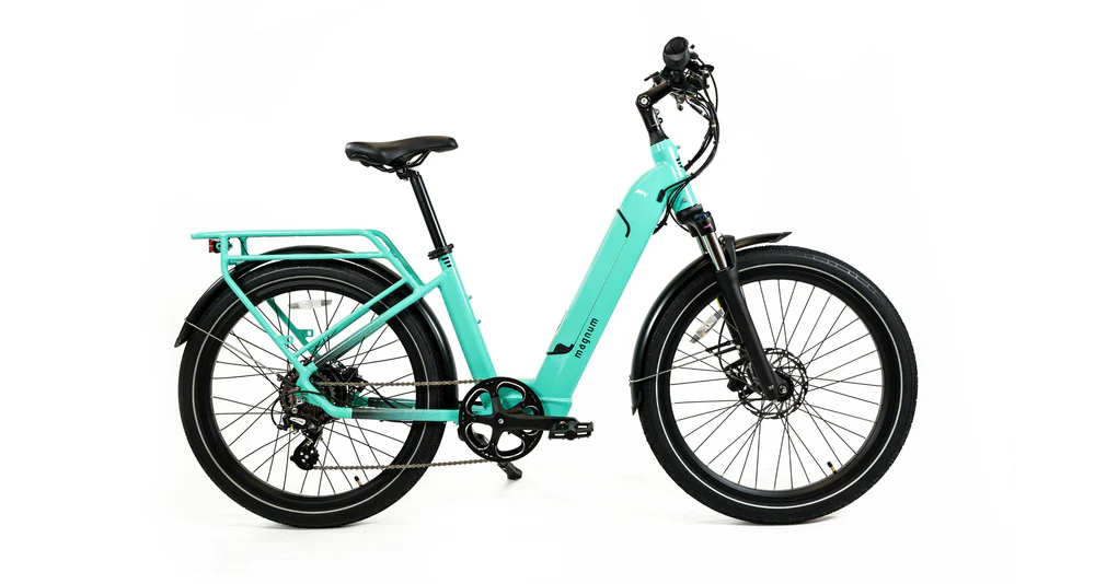 The Magnum Cosmo 2.0 T by Magnum is shown in profile on a white background, featuring a turquoise low-step frame, black seat, rear rack, front suspension, and disc brakes.