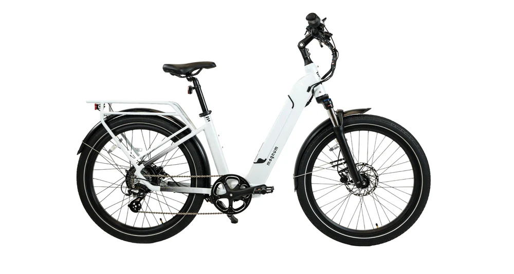 The Magnum Cosmo 2.0 T e-bike by Magnum, shown in a white low-step frame with a front suspension fork, rear cargo rack, and disc brakes, is pictured from the side against a white background.