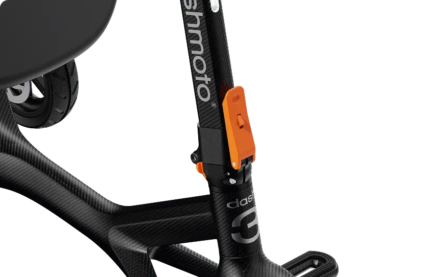 Close-up of the Dashmoto Dash 3’s carbon fiber frame with "Dashmoto" branding and an orange latch—a stylish, foldable mobility scooter that combines convenience with modern design.