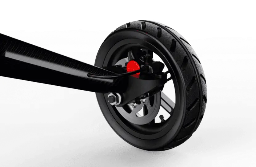 Close-up of the Dashmoto Dash 3’s carbon fiber wheel showing tire tread, disc brake, and red caliper, by Dashmoto, against a white background.