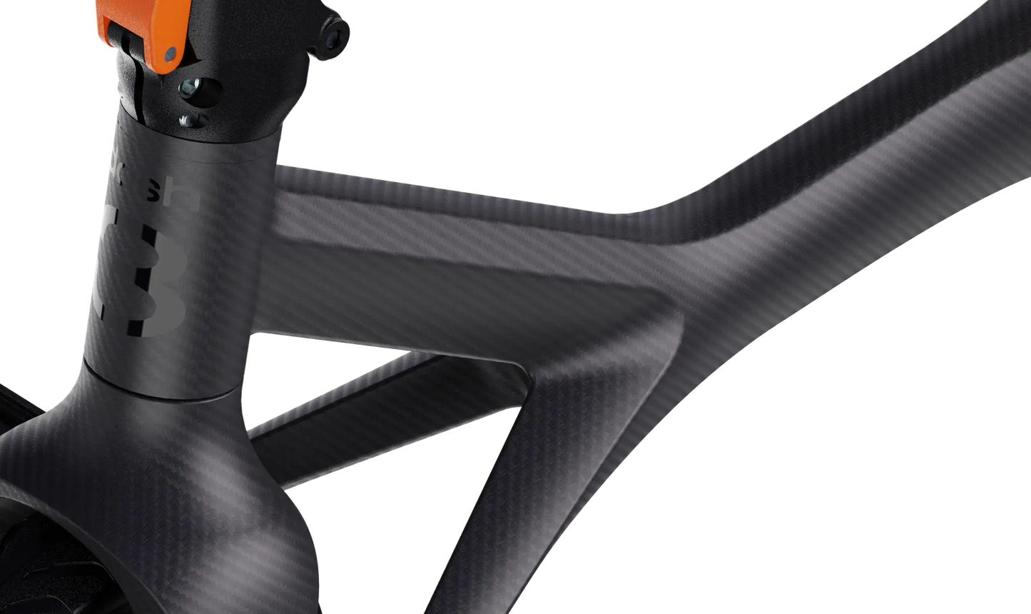 Close-up of the Dashmoto Dash 3 scooter frame by Dashmoto, highlighting the matte black top tube, down tube, and seat tube junction in carbon fiber.