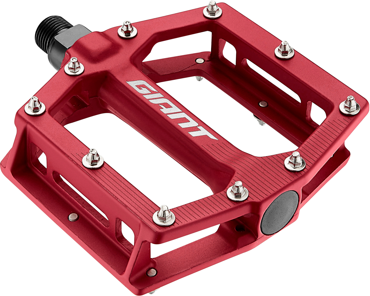 Red scallop-shaped platform bicycle pedal with metal pins and Giant branding engraved, ensuring a stable grip.