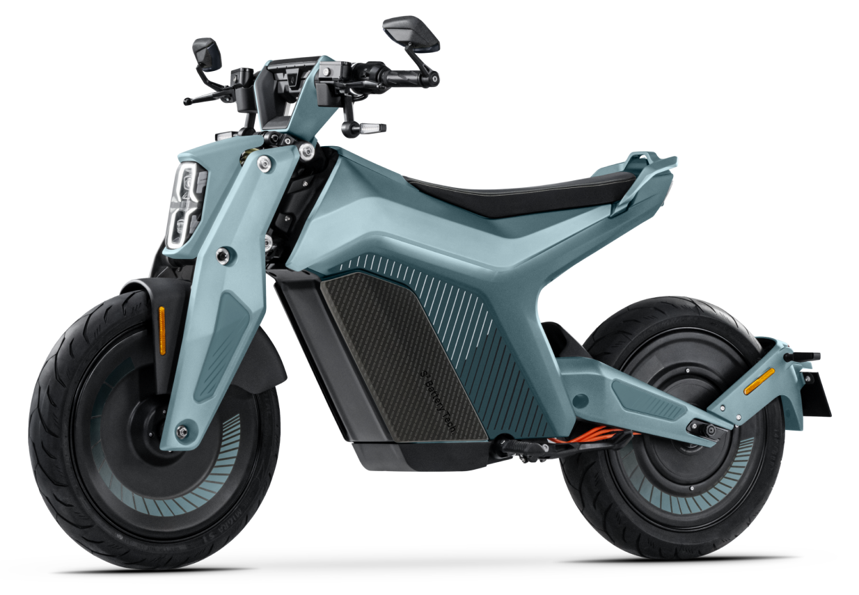 A modern Naxeon - I AM electric motorcycle from Naxeon in light blue, showcasing a sleek design with thick tires, a single seat, and minimalistic handlebars for high-performance urban mobility.