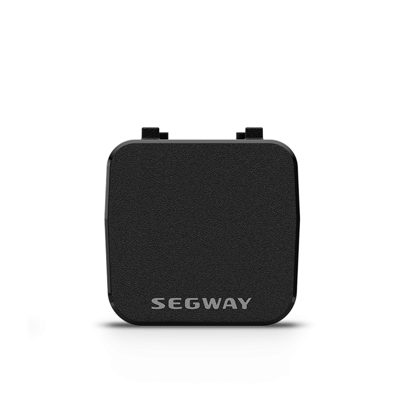 A black, square Segway - Myon Rearview Radar with a textured surface and two small top tabs is shown on a white background. This device by Segway enhances bike safety by providing real-time traffic alerts.