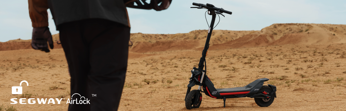 A person approaches a Segway ZT3 Pro eKickScooter on sandy desert terrain, showcasing its advanced suspension for off-road prowess. The Segway logo and "AirLock" text are visible in the corner.