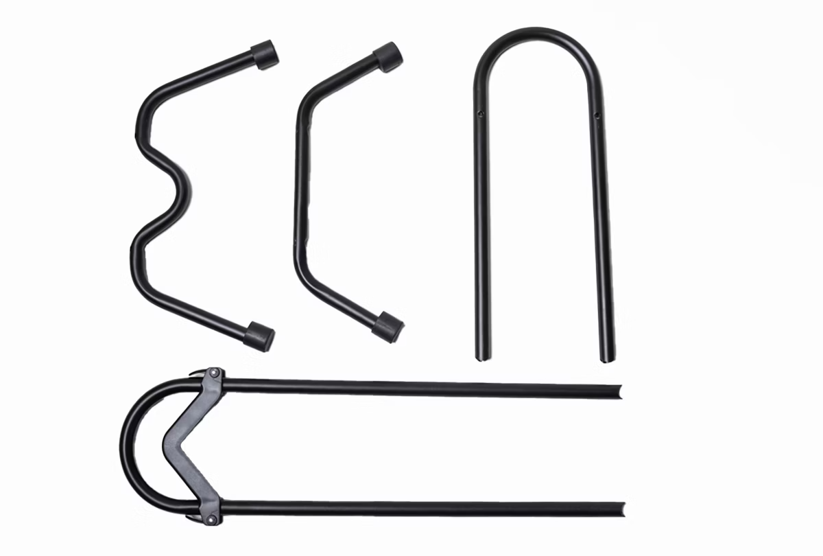 The Aventon - Floor Rack set includes four durable aluminum bike lock pieces in sleek black: two U-shaped and two straight with angled ends, arranged on a white surface.