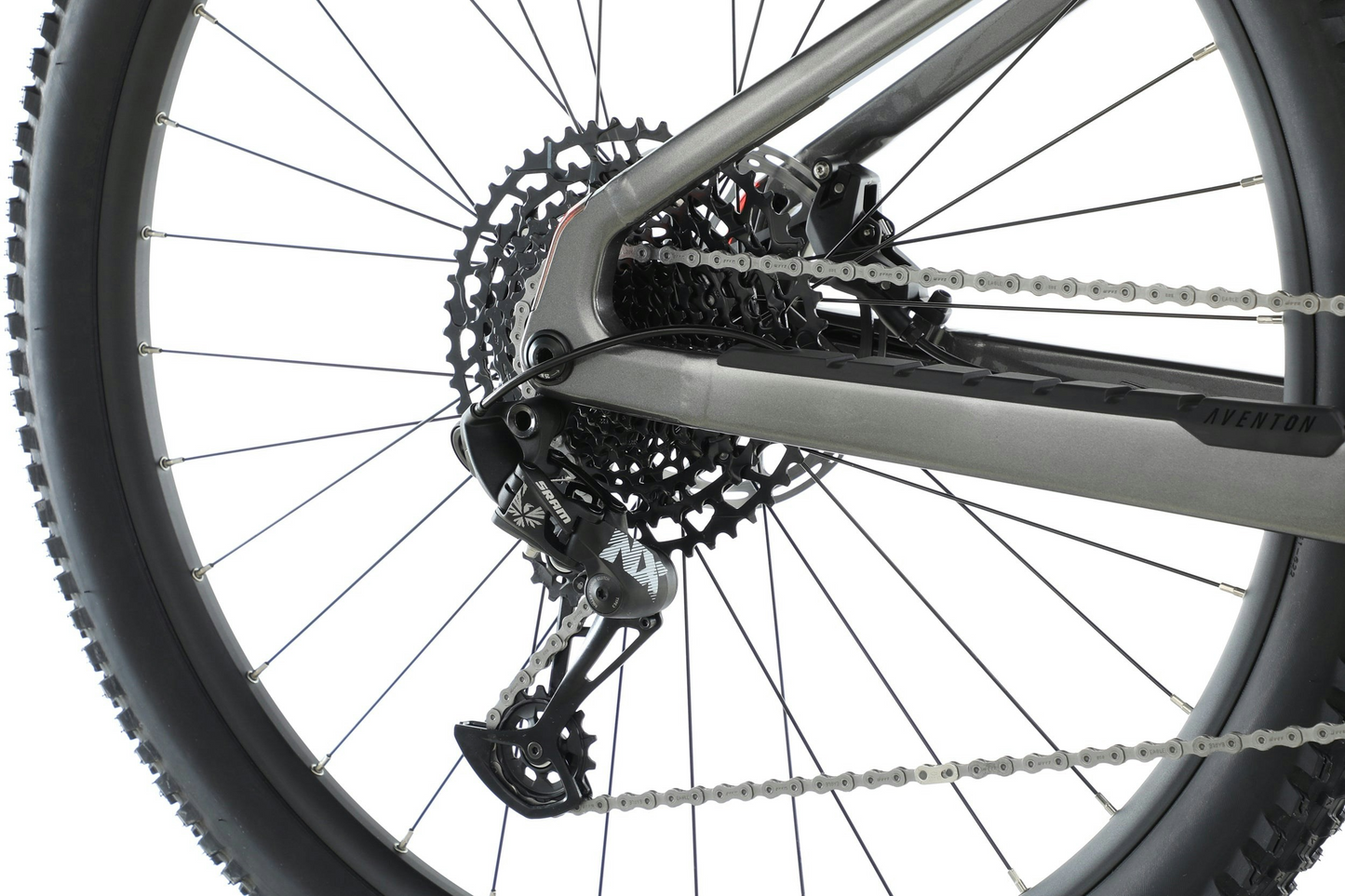 Close-up of an Aventon Ramblas eMTB's rear derailleur and cassette on a white background.