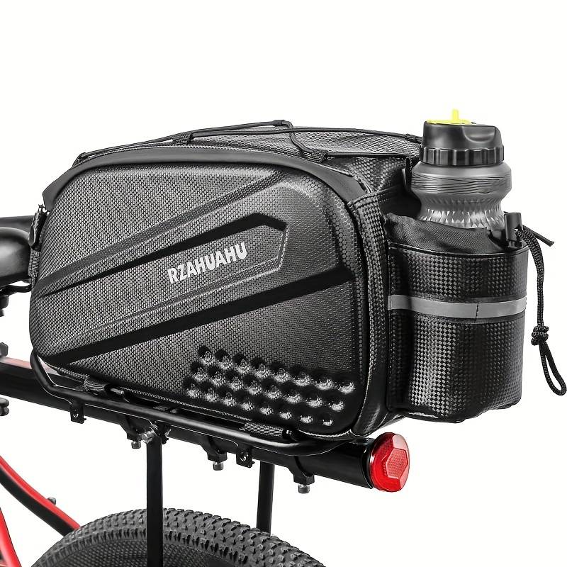 A black bicycle pannier bag labeled "Bag - Rear Wheel Up" by Tampa Bay eBikes is attached to a rack, with a water bottle in its side pouch. The bike features a red frame and includes a rear light.