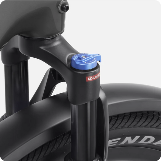 Close-up of a Velotric Discover 2 electric bike suspension fork with an adjustment knob, showcasing advanced Velotric eBike engineering.