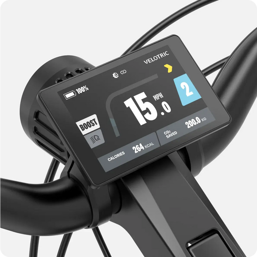 A Velotric - Discover 2 electric bicycle's handlebar-mounted display showing speed, battery level, and other data.