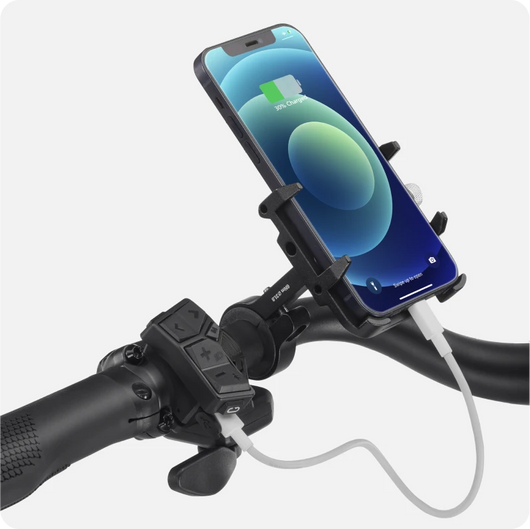 Smartphone mounted on a Velotric Discover 2 electric bike handlebar with a charging cable connected.