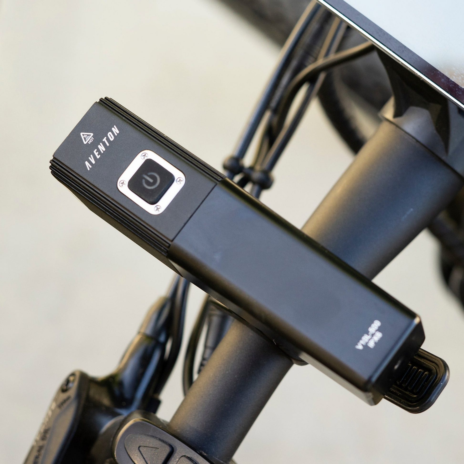 A Aventon safety camera attached to the handlebar of a bicycle, designed for low-light conditions.
