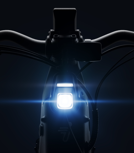 Close-up of a Segway - Xafari handlebar with an illuminated front light, highlighting its futuristic design, extended range, and central control display against a dark background.