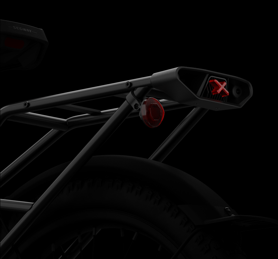 Close-up of the Segway - Xafari's rear frame featuring a red reflector light and an X-shaped taillight, set against a sleek black background.