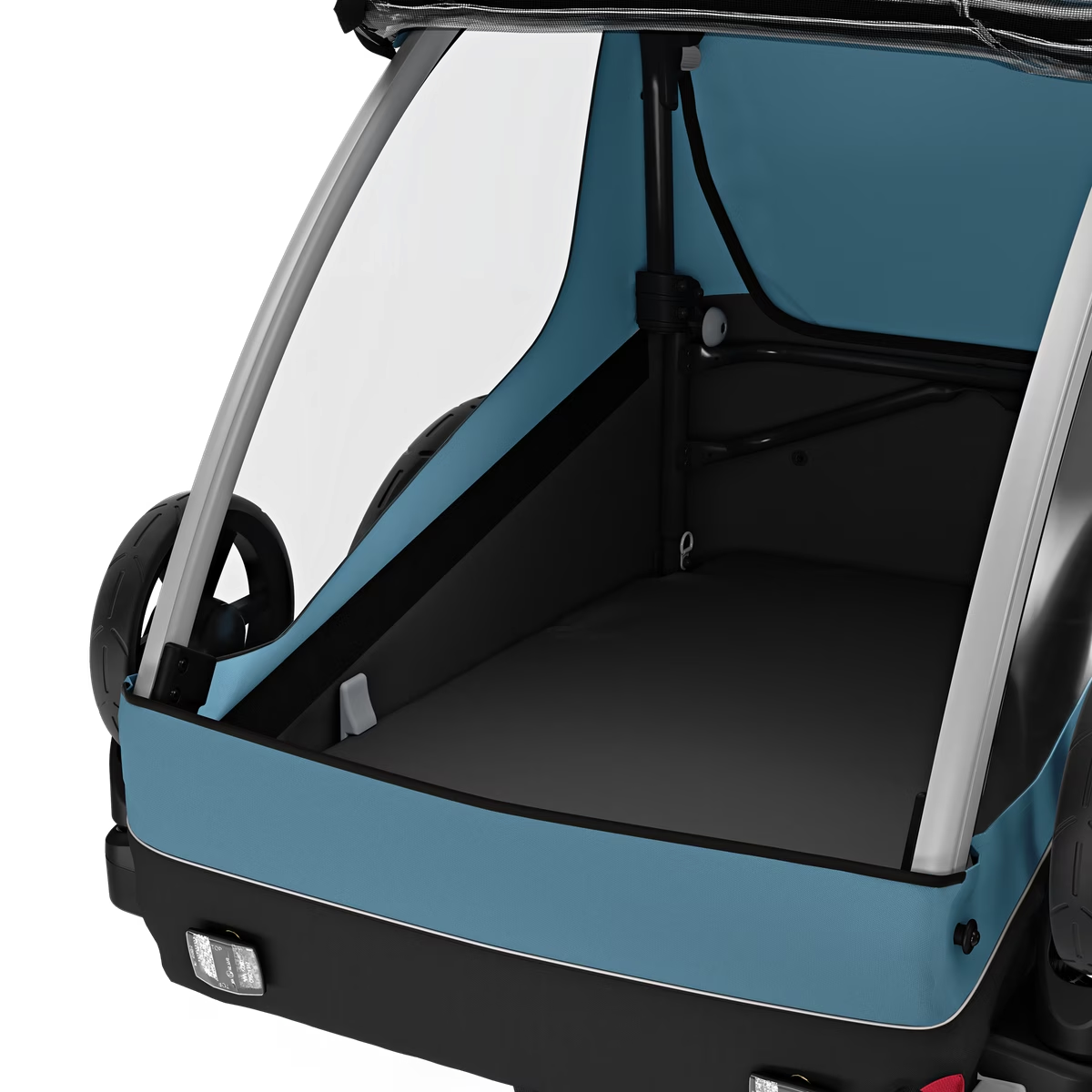 A rear view of the Thule Courier Child Trailer, perfect for family outings, showcasing its spacious interior with a sleek blue and black color scheme.