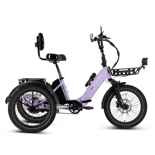 The Lectric XP Trike 2 by Lectric is a lavender long-range electric tricycle, featuring a rear backrest seat, front basket, and three large wheels, displayed in profile against a white background.