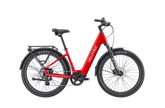 A red Velotric - Discover 2 with a step-through frame, black tires, and rear cargo rack showcases advanced eBike engineering. Available at Tampa Bay eBikes.