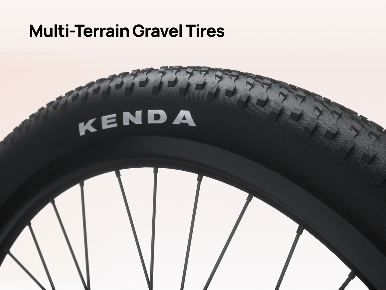 Close-up of a black Velotric multi-terrain gravel tire with textured tread, perfect for the Velotric Discover 3 commuter eBike, shown mounted on a spoked wheel against a light background.