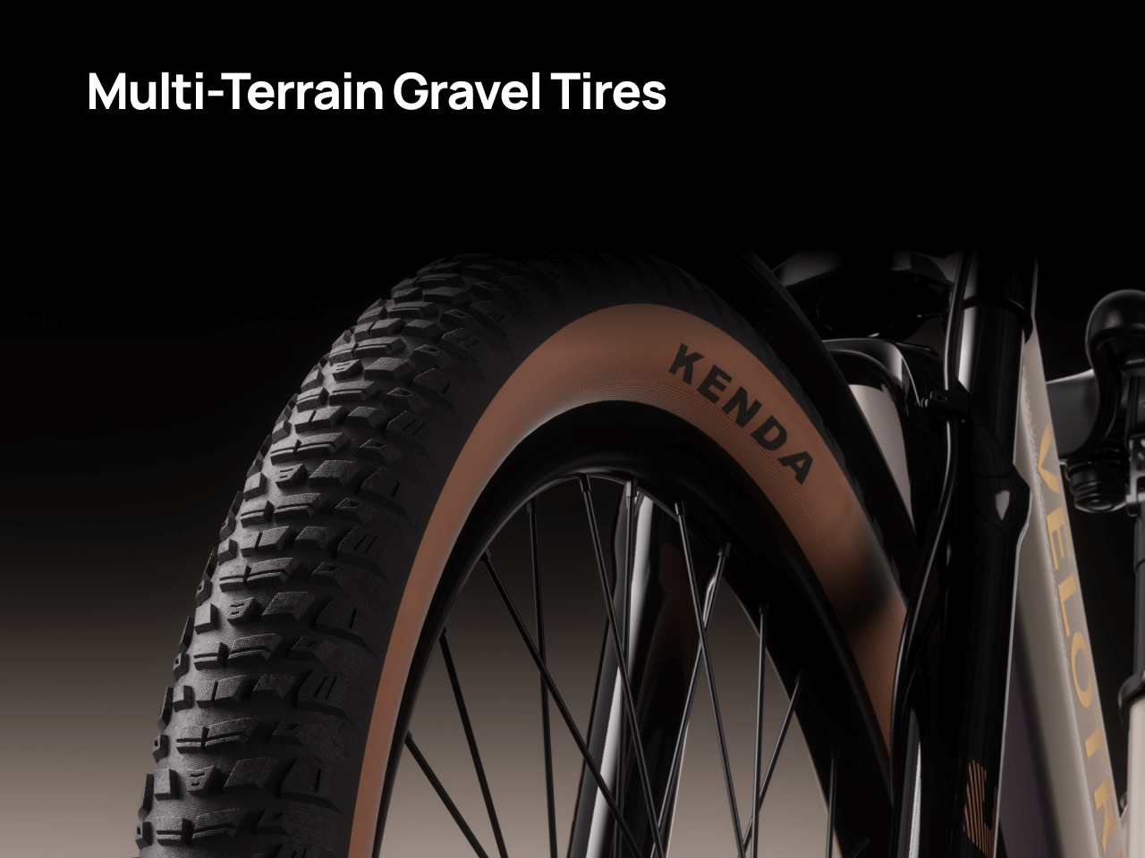 Close-up of the Velotric Discover M eBike's wheel, featuring a Kenda tire labeled "Multi-Terrain Gravel Tires," showcasing tread designed by Velotric for versatile riding surfaces.