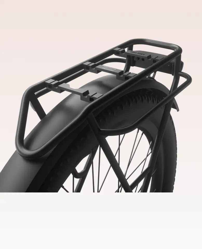 Close-up of a black rear bike rack mounted above the back wheel and fender of the Velotric Discover 3 commuter eBike by Velotric.