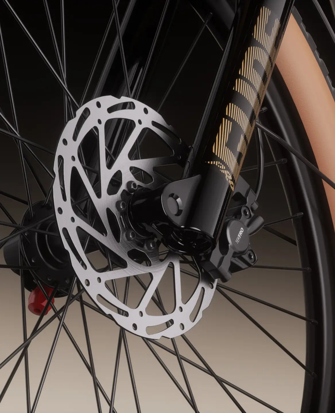 Close-up of the Velotric Discover M by Velotric, featuring its front wheel with a disc brake rotor, caliper, black spokes, and a tan sidewall tire.