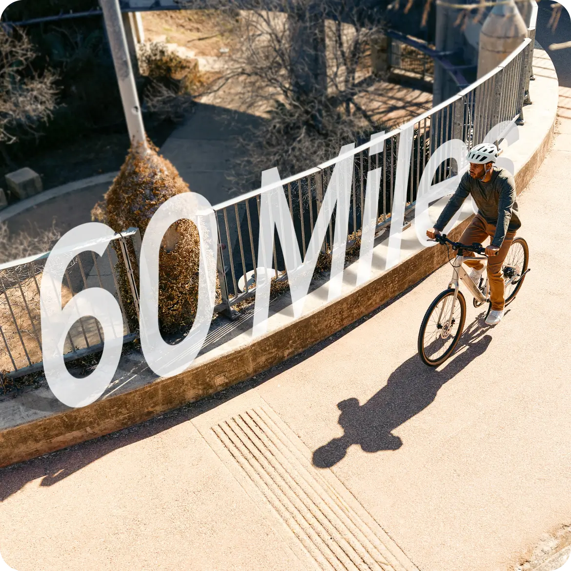 A cyclist rides alongside a fence under the sun, with bold "60 Miles" text highlighting the Velotric Tempo e-bike’s impressive range and advanced torque-sensing technology from Velotric.