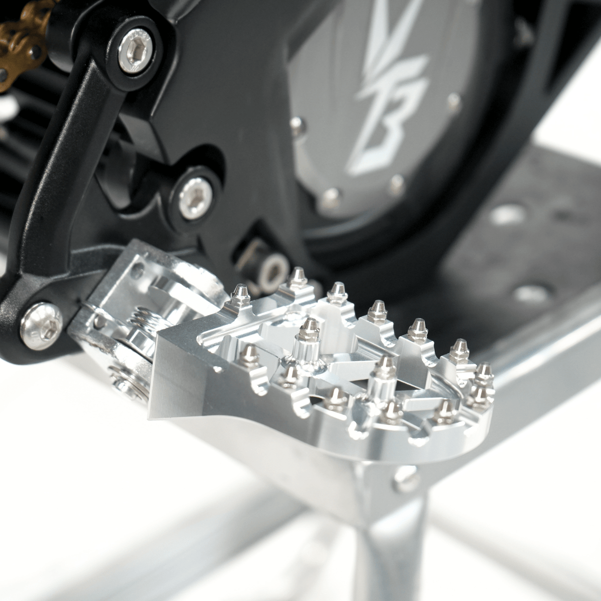Ventus V1+ EVO electric dirt bike, foot peg and motor cover close-up
