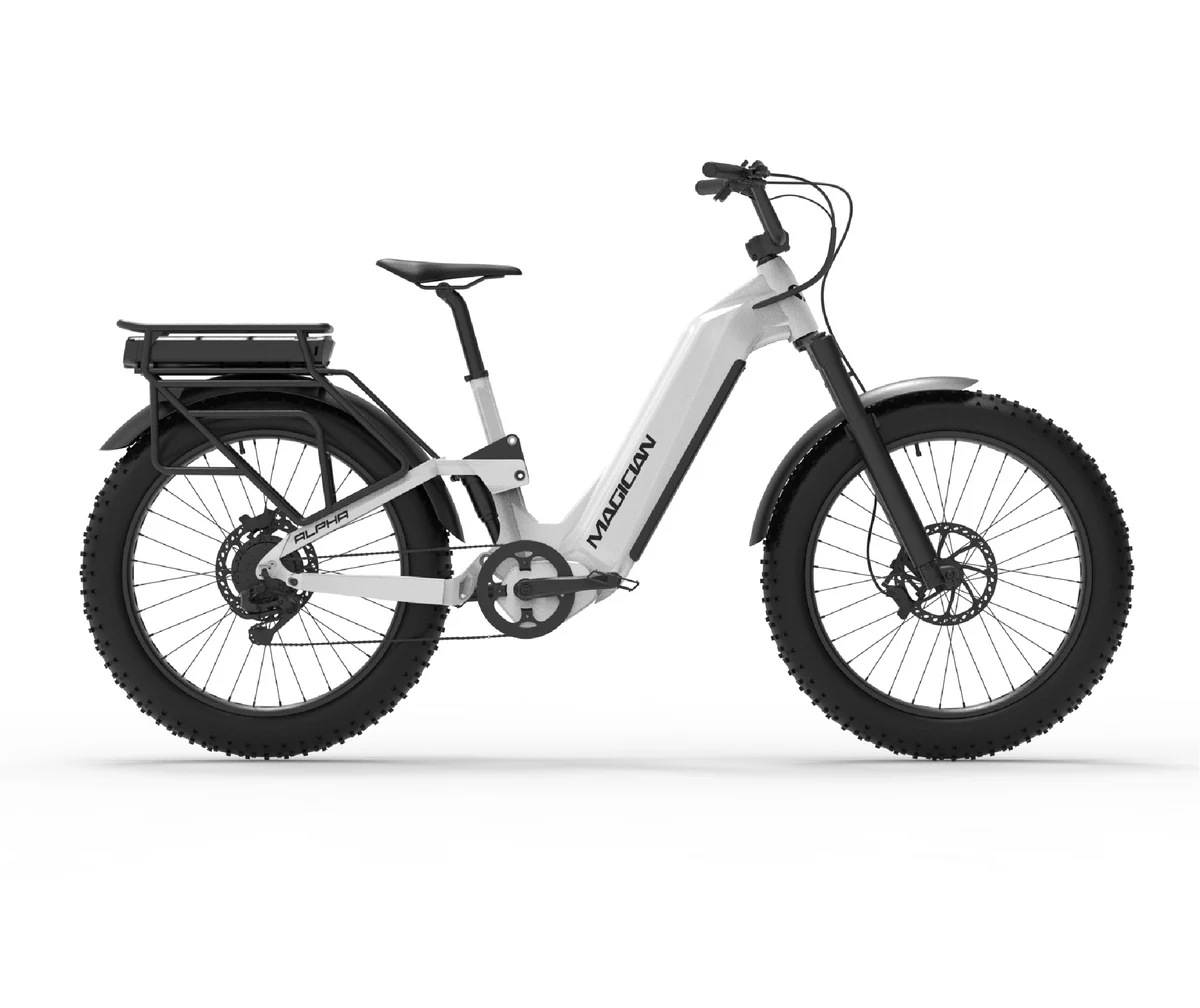 The Magician Alpha by Magician is a high-performance electric bike with a step-through frame, wide knobby tires, rear cargo rack, front suspension fork, and disc brakes, shown from the side.