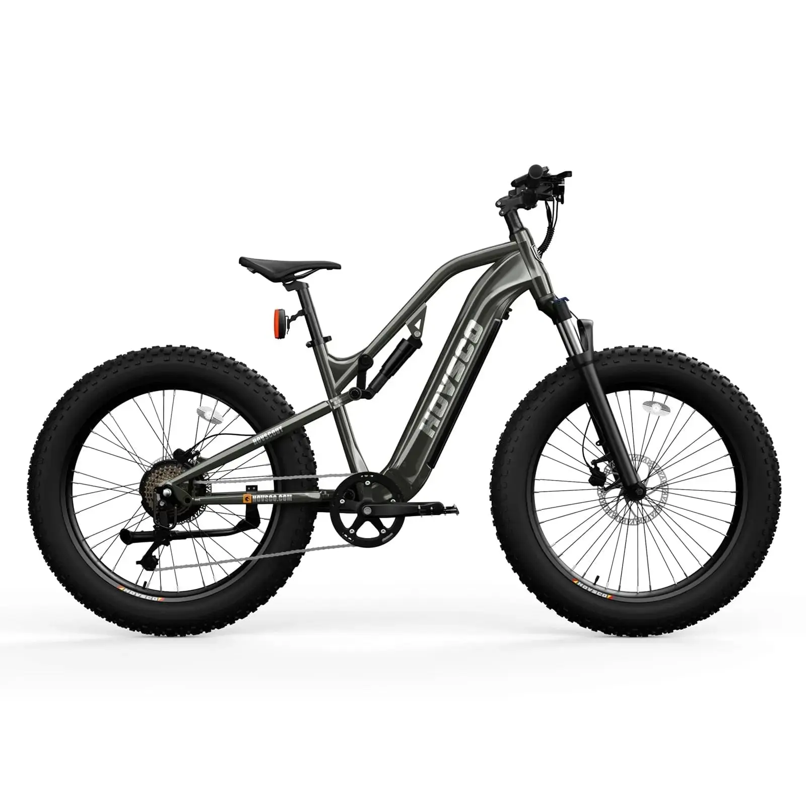 Side view of a Hovsco - Scout in grey, an electric fat tire bike with a matte black finish, featuring thick, knobby tires, a front suspension fork, rear four-bar linkage suspension, and a sturdy frame.